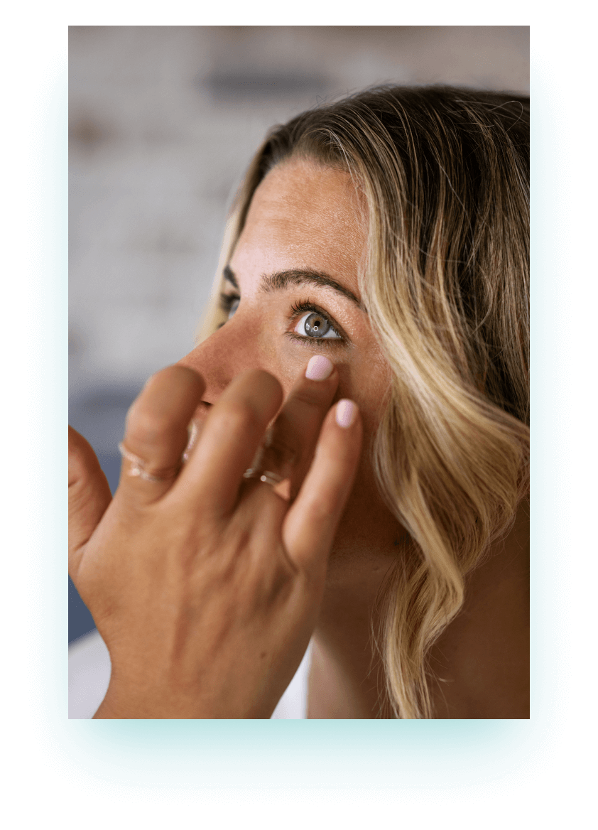 Woman applying eye drops